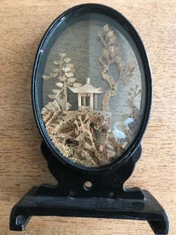 Vintage Chinese Cork cutout behind glass 